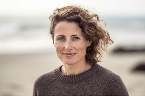a beautiful fresh faced woman in a chocolate brown crew neck sweater