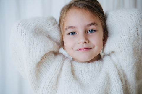 a beautiful girl wearing a fluffy white woollen knit