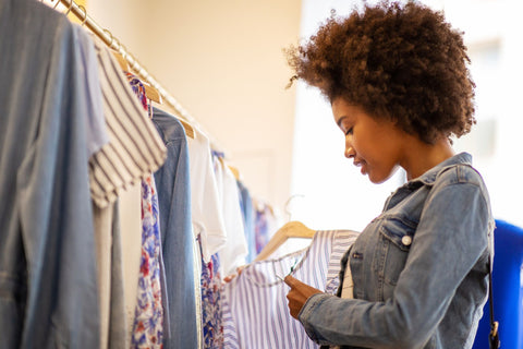 a woman shopping for clothes in a store