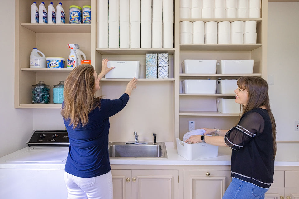Kate and Ann working as a team in a laundry space