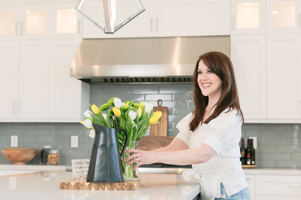 Laura in a beautiful kitchen with a vase of tulips to add a touch of bright color