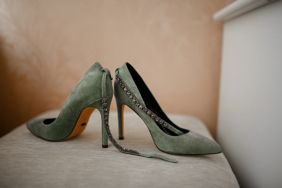 a pair of sage green stilettos with diamante ankle straps