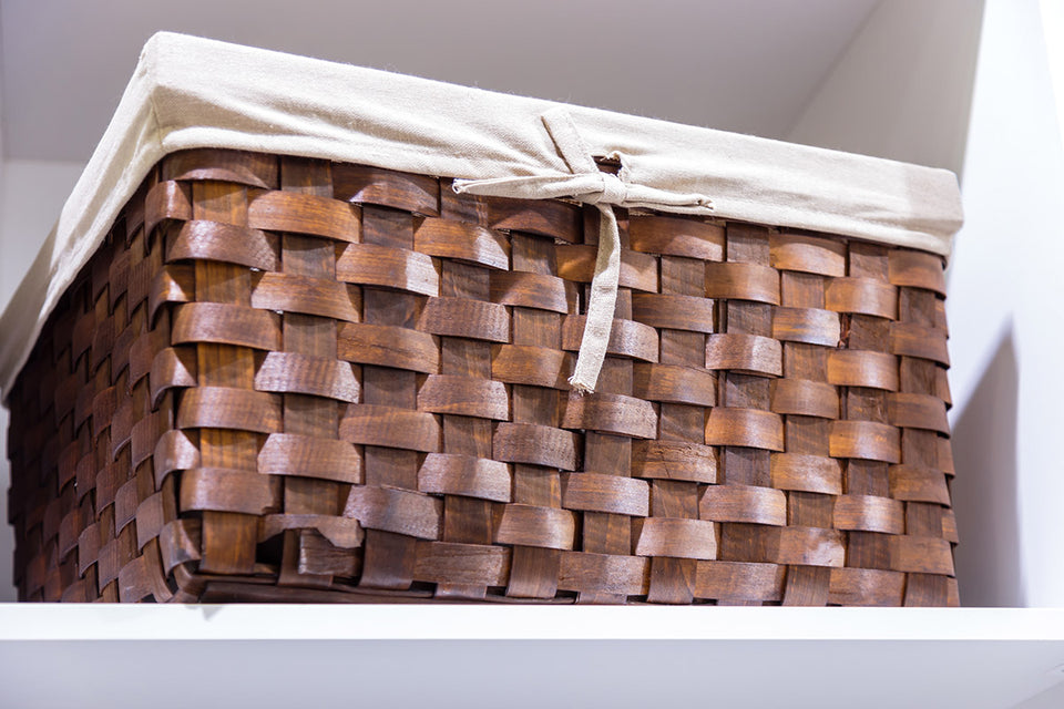 a woven basket for clothing storage