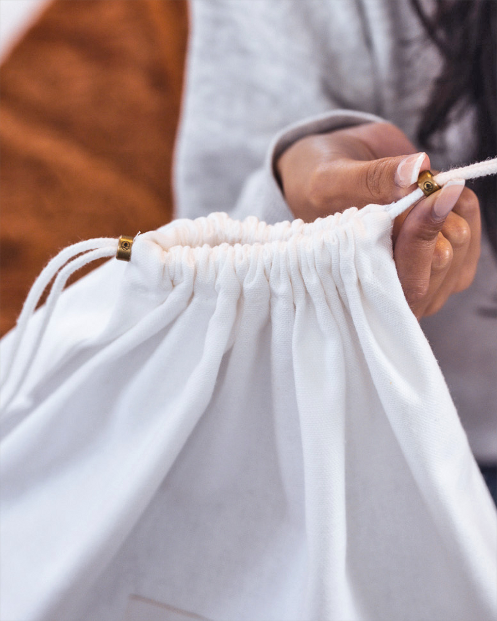 Hayden Hill dust bag being closed using the drawstring