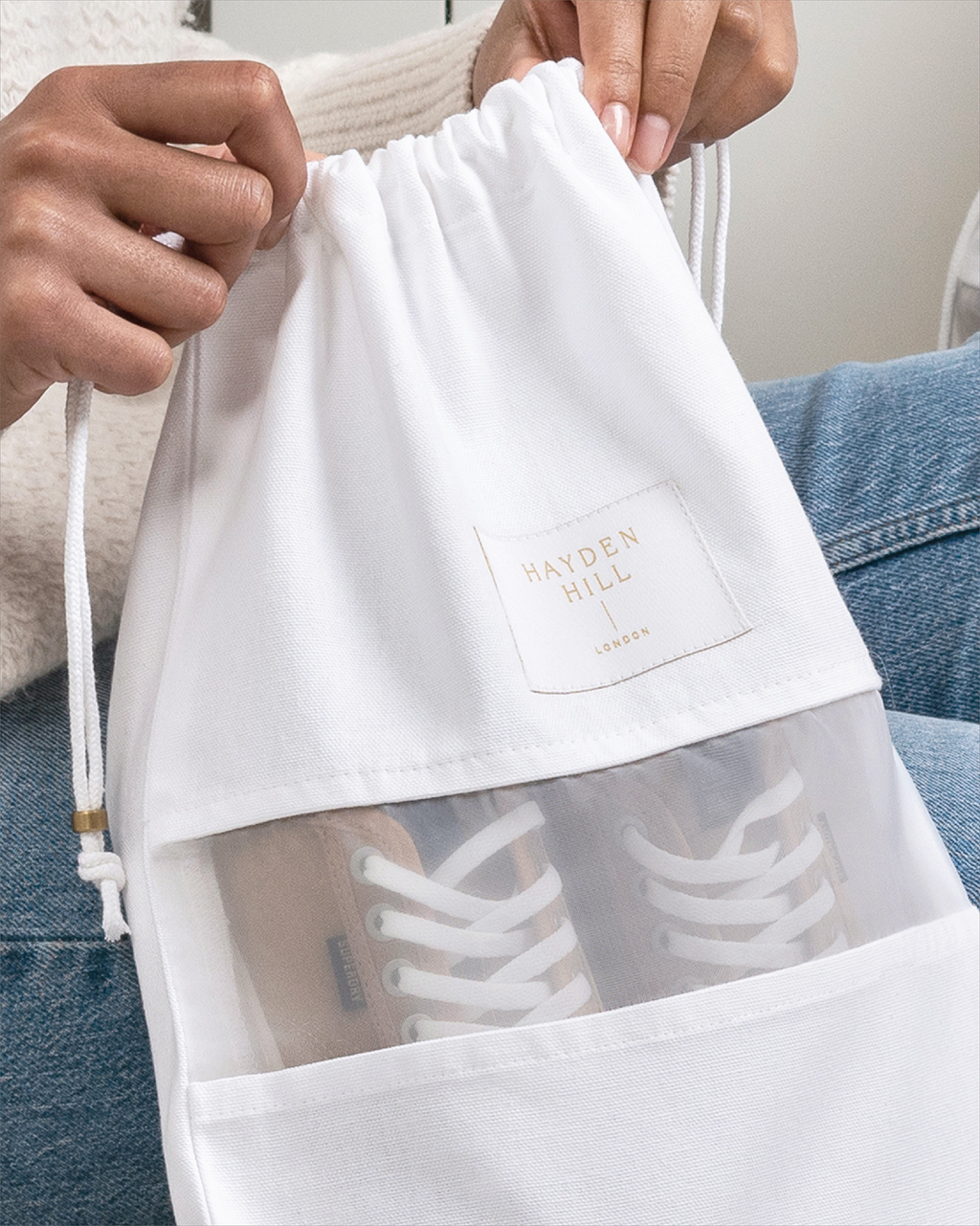 a close up of a Hayden Hill dust bag with a pair of sneakers inside