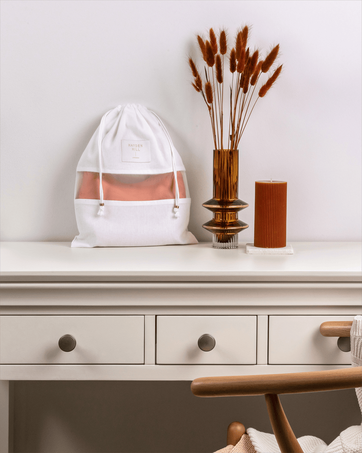 a small dust bag sitting on a dressing table