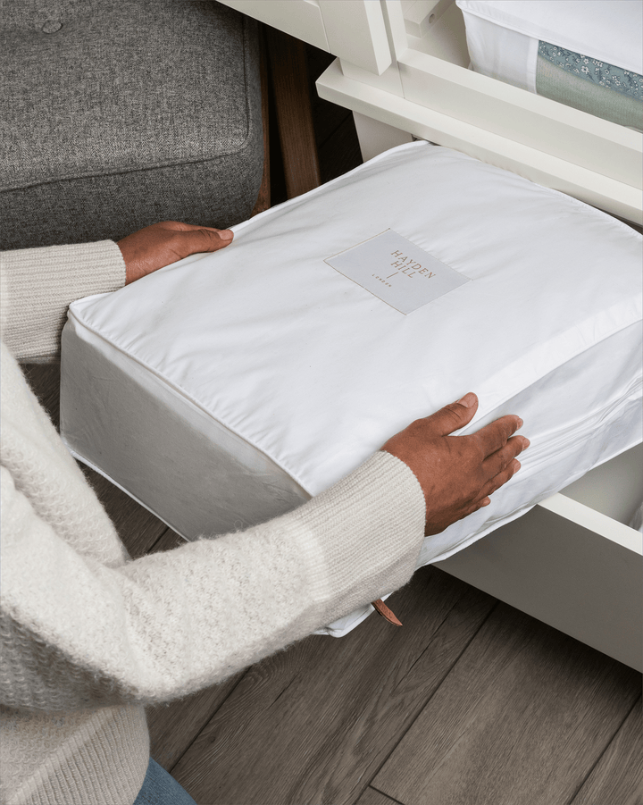a storage bag being placed in a drawer