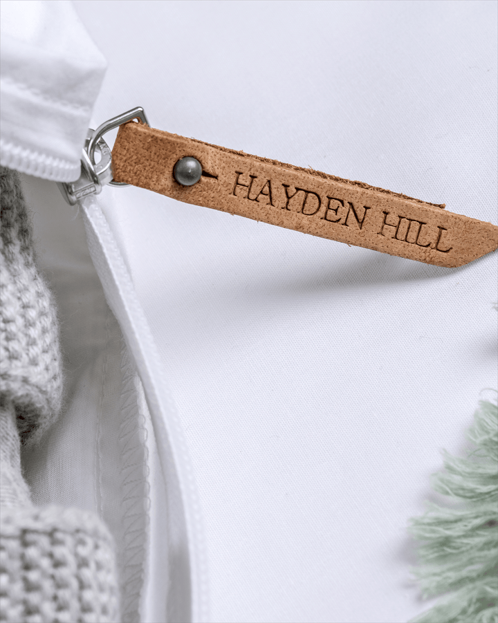 a close up of the Hayden Hill leather zipper pull on a storage bag