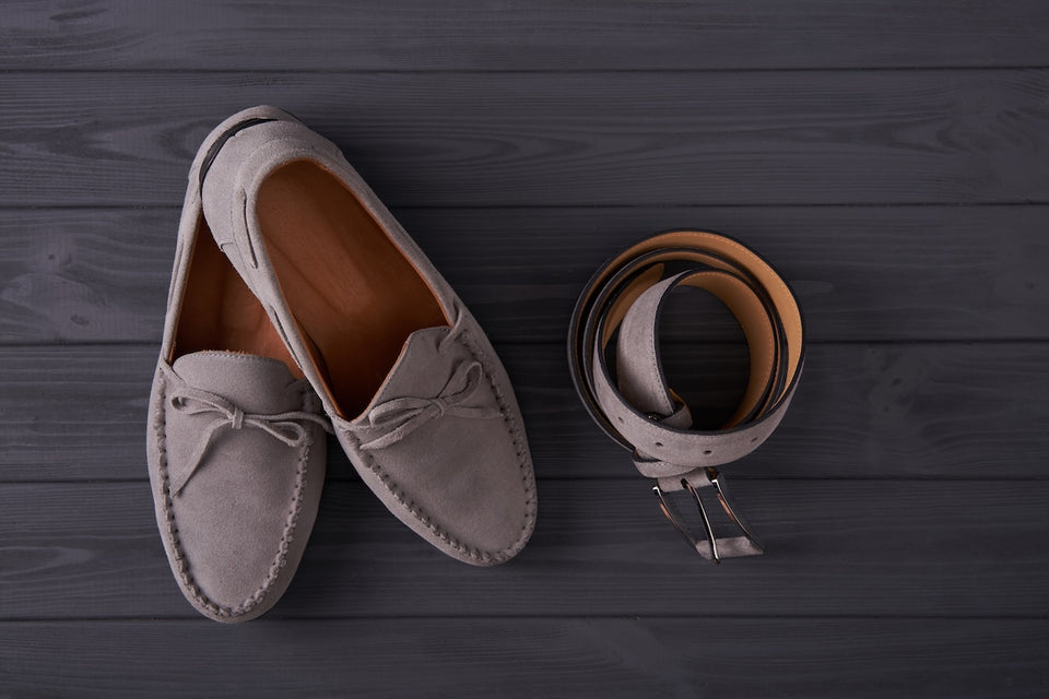 a pair of brown suede moccasin shoes and a matching suede belt