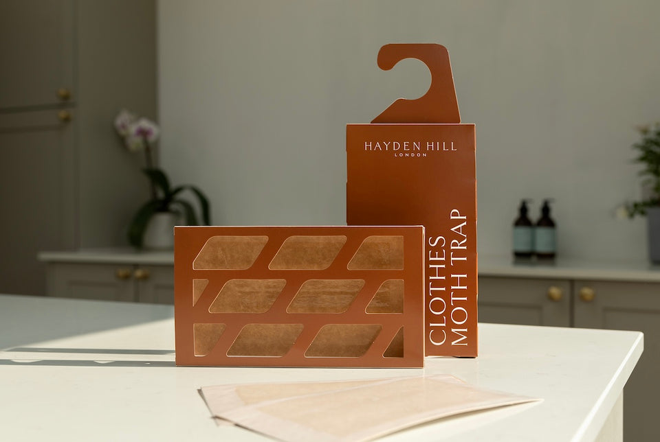 a Hayden Hill Clothes Moth Trap pictured lying on its side and with a hanger attached