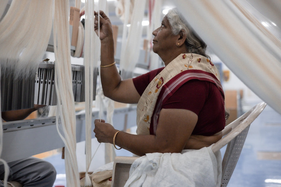 a woman worker at the factory where the weaving takes place