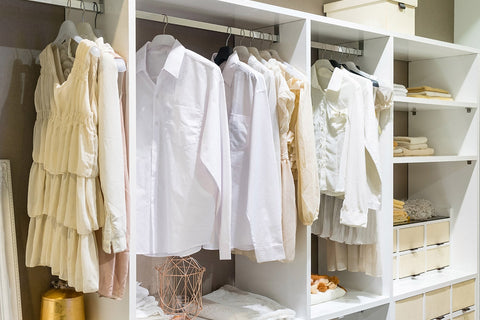 a closet full of shirts and short dresses in spring colours