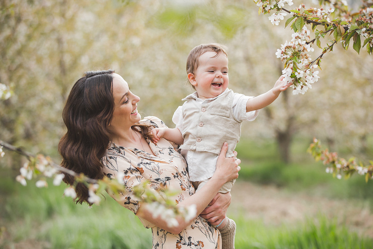 a mother and child admiring the Spring blossom