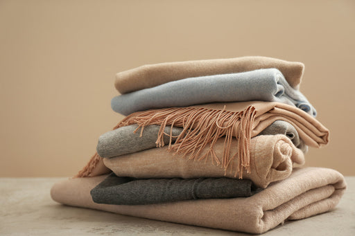 a pile of cashmere sweaters