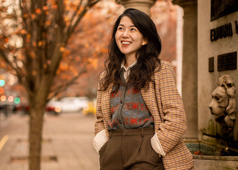 Mai looking chic wearing a vintage style jacket, vest and trousers