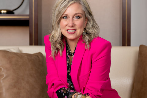 Suze channels her personal style wearing a patterned shirt with a fuschia pink blazer