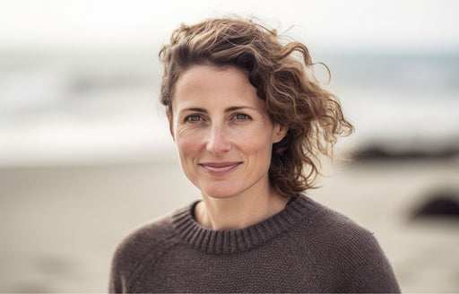 a beautiful fresh faced woman in a chocolate brown crew neck sweater