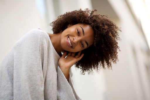 a beautiful woman wearing a pale gray soft wool poncho