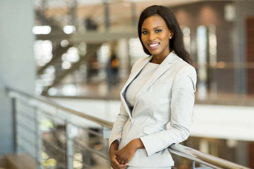 a businesswoman wearing  smart summer ecru coloured suit