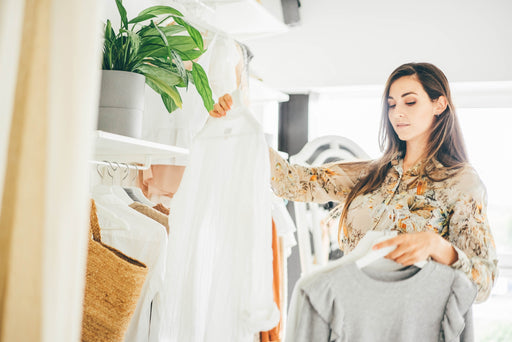 a fashionable woman choosing clothing in a store