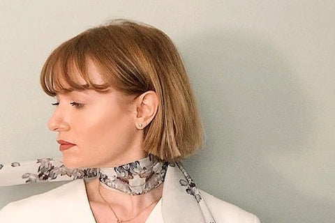 a headshot of Lauren Catris wearing one of her silk scarves