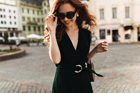 a stylish woman wearing a dark green velvet dress