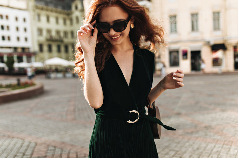 a stylish woman wearing a dark green velvet dress