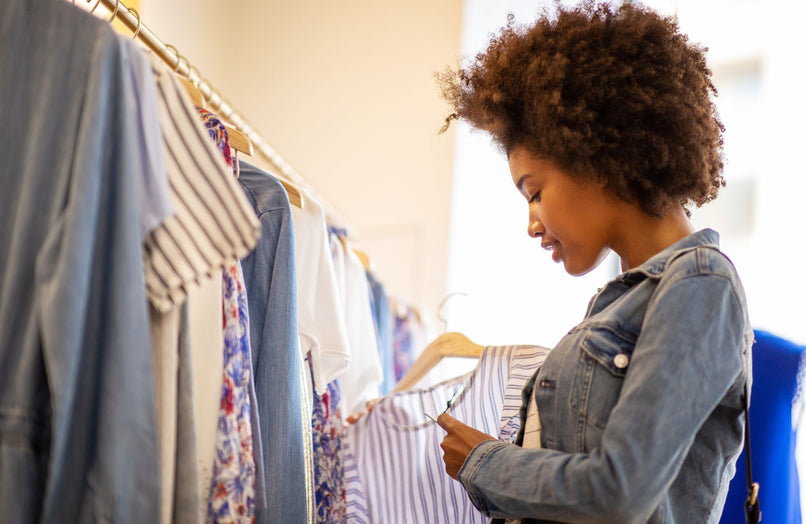 a woman shopping for clothes in a store