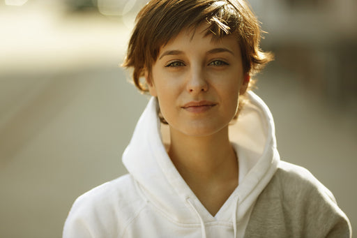a woman wearing chic hoodie in gray and white