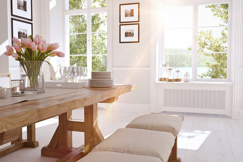 beautiful sunny dining room with tulips in a vase on the table