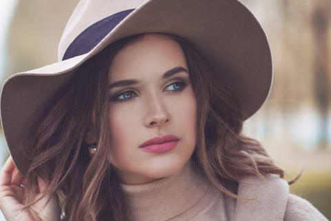 beautiful woman in a cashmere roll neck and felt fedora