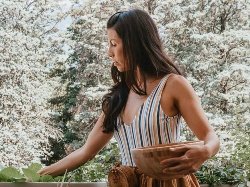 Danielle holding a hand-crafted wooden bowl