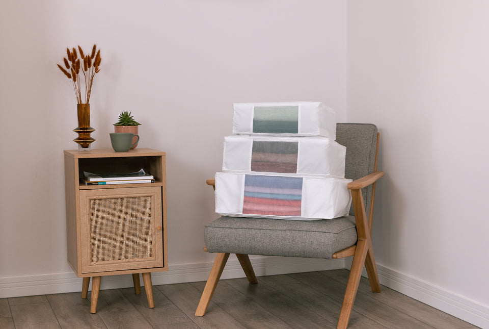 Three sizes of Hayden Hill storage bags stacked on top of each other on an armchair