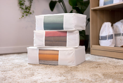 a stack of Hayden Hill Storage Bags with see-through organza panels showing the contents inside