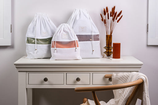 Hayden Hill Dust Bags in small, medium and large sitting on a side table