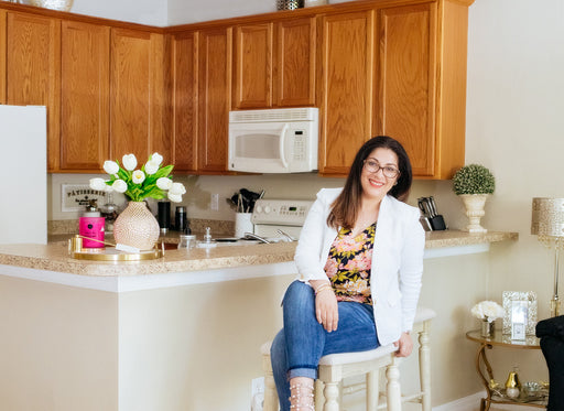 Nathalie seated at the breakfast bar in her kitchen