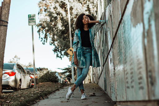 Tyler showing her gift for combining chic and casual with denim cut-offs and a long shirt