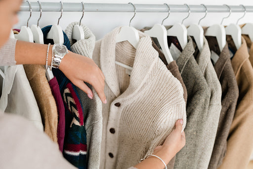 a assortment of hanging woolen jackets and knitted cardigans