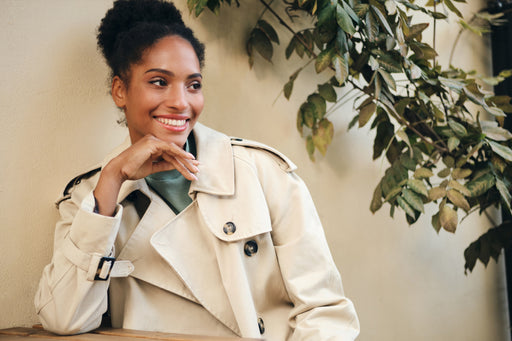 a beautiful woman wearing a stylish ecru trench coat 