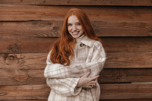 a beautiful young woman in a large soft wool plaid jacket