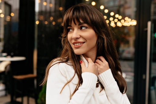 a chic woman wearing a white woolen sweater
