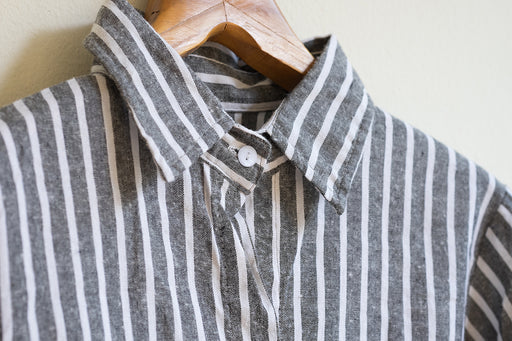 a close up of a black and white striped linen shirt