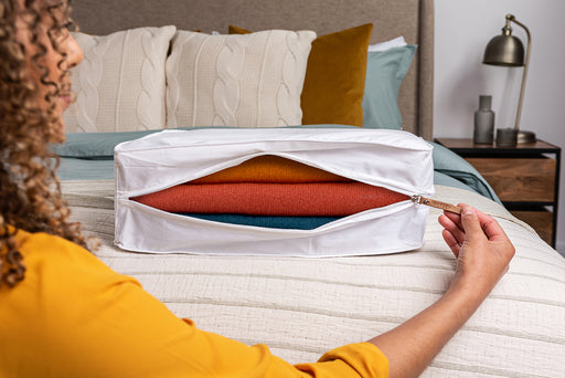 a close up of a woman opening a Hayden Hill Storage Bag and looking at the woolens stored inside