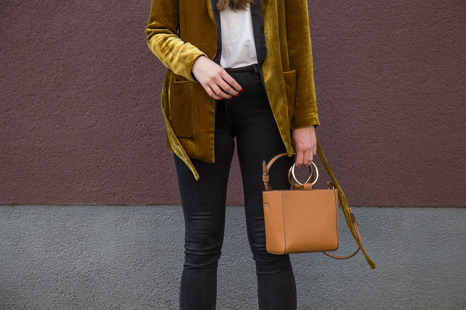 a close up of a woman wearing a beautiful gold velvet jacket