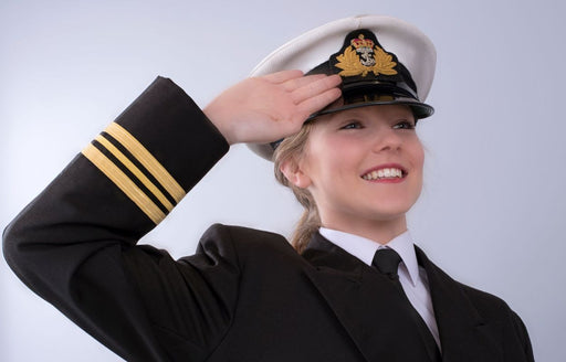 a close up of a young female naval officer saluting