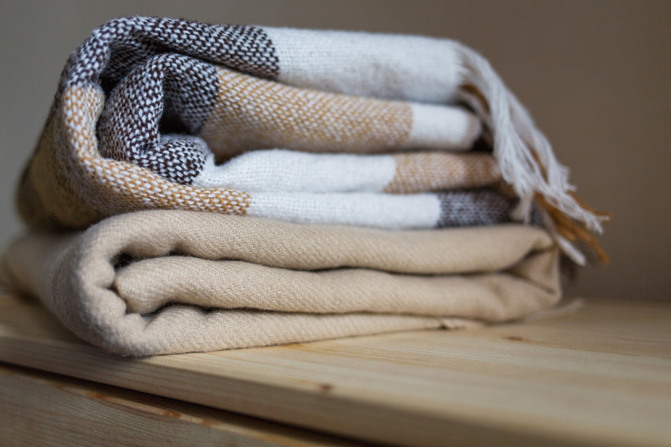 a couple of woollen folded blankets