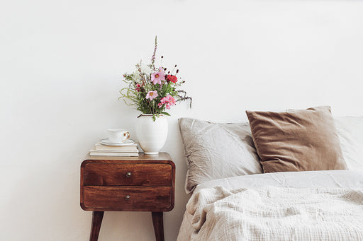 a dark wood bedside table