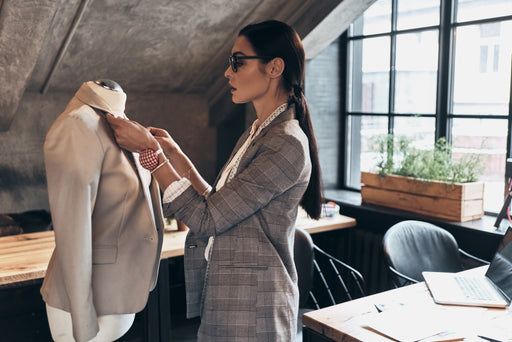 a fashion designer working on a classic jacket design in her atelier