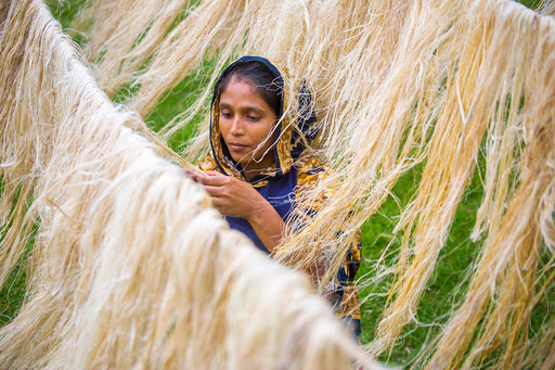 a female worker processing the fibers from pineapple leaves