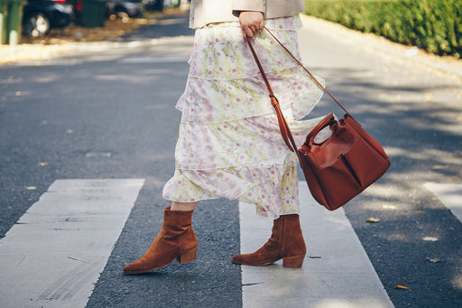 a floral layered skirt with tan handbag and suede tan ankle boots